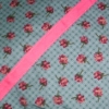 Cotton printed with thin intersecting stripes and small flowers